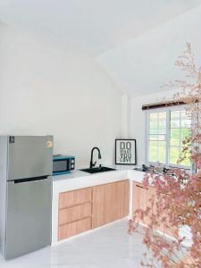 a kitchen with a refrigerator and a sink at PAI LAMUN VALLEY in Pai