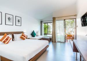 a bedroom with a large white bed and a desk at Family House Zen Boutique Resort in Pai +37 photos
