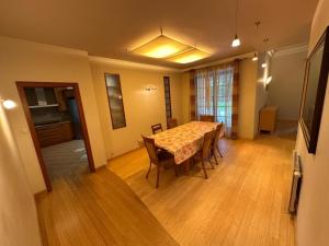 a dining room with a table and chairs at Anna Maria in Łomianki