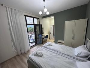 a bedroom with a bed and a large window at HIQ Hotel Home Inn Qusar in Qusar