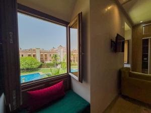 a room with a window with a view of a pool at Riad Azia in Marrakesh