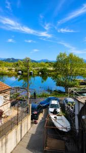 a boat parked in a parking lot next to a lake at Apartments Skadar Lake in Vranjina