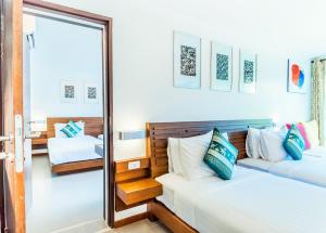 two beds in a room with a mirror at Family House Zen Boutique Resort in Pai