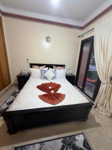 a bedroom with a bed with a flower on it at Dar Fayz in Marrakesh
