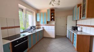 a kitchen with blue and white cabinets and a sink at Noclegi Słodki Sen 2 in Lublin +65 photos