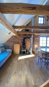 a room with a bed and a table and a brick wall at Grudza83 Bikepoint in Mirsk