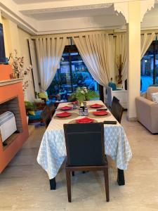 a dining room with a table and a couch at Dar Fayz in Marrakesh