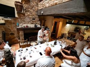 a group of people sitting around a table in a room at Arribes del Duero casa rural Balneario, hotel rural Bermellar y Camino de Hierro in Bermellar