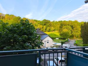 a balcony with a view of a parking lot at Appartement La Parenthèse Verte - Capvern in Capvern
