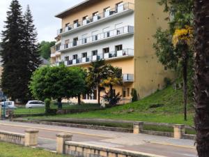 a large building on the side of a street at Appartement La Parenthèse Verte - Capvern in Capvern +7 photos
