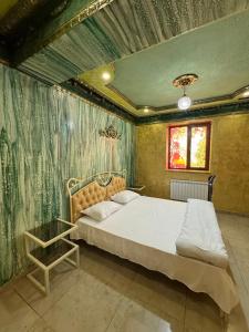 a bedroom with a bed and a table in it at Veradarc Hotel & Restaurant in Noratus +20 photos