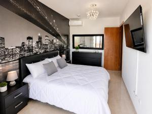 a bedroom with a large white bed and a television at Casa Roda de Bará & Spa in Roda de Bará