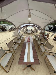 a group of chairs and tables on a beach at camp asri in Bukittinggi