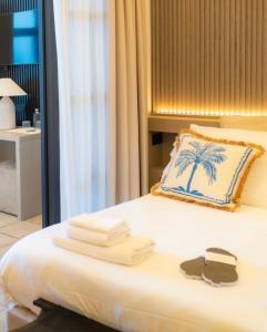 a hotel room with a bed with towels on it at Al Capri Suite & Private Pool in Capri