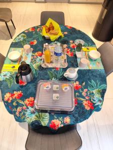 a table with a table cloth on it with a breakfast at Les ANGES DE SAINTE ANNE in Plumergat