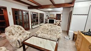 a living room with two chairs and a coffee table at White Wolf Chalet in Bansko