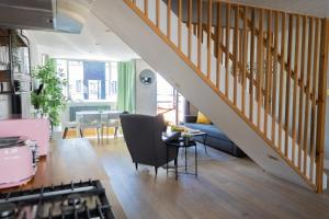 a living room with a staircase and a dining room at Boutique-Style Apartment in Heart of Brighton Lanes in Brighton & Hove