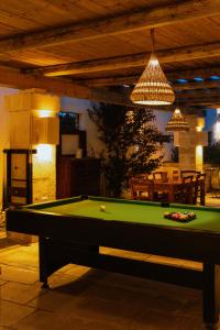 a pool table in the middle of a living room at Masseria Messapia Wine Resort & Spa Salento in Mesagne