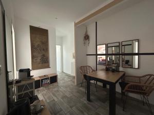 a living room with a wooden table and chairs at Maison en pierre in Saint-Cyr