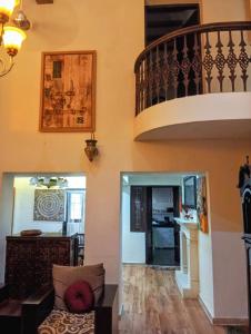 a living room with a staircase in a house at Charming Stone Cottage in erstwhile grape gardens in Secunderabad