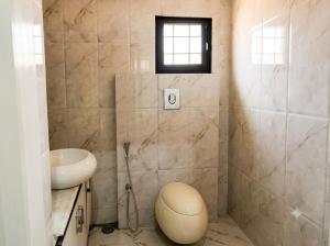 a bathroom with a sink and a toilet in it at Charming Stone Cottage in erstwhile grape gardens in Secunderabad +23 photos
