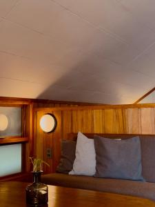 a couch sitting in a room with wooden walls at The Lark Inn & Kitchen in San Juan