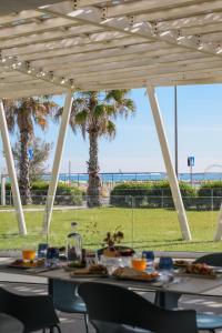 a table with food and a view of the beach at Blu Suite Resort in Bellaria-Igea Marina