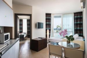a hotel room with a kitchen and a living room at Blu Suite Resort in Bellaria-Igea Marina