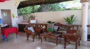 a living room with a couch and chairs and a table at AGM Beachfront Resort in Donsol