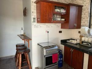 a kitchen with a stove and a counter top at Mukisa Apartments in Kampala