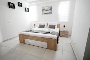a bedroom with a bed in a white room at Central Penthouse with massive terrace in San Ġwann