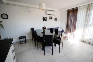 a kitchen and dining room with a table and chairs at Central Penthouse with massive terrace in San Ġwann +32 photos