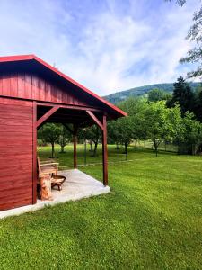 a redshed with a bench and a wooden bench istg at Chalupa v Beskydech in Trojanovice