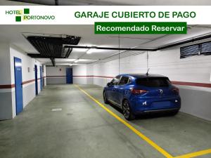 a blue car parked in a parking garage at Hotel Portonovo in Portonovo
