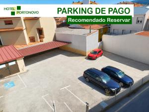 two cars parked in a parking lot next to a building at Hotel Portonovo in Portonovo