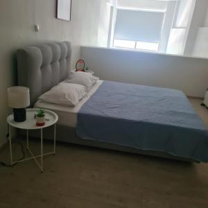 a bedroom with a bed and a table and a window at loft ΑLEXIA in Pyrgos