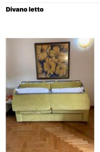 a couch in a room with a painting on the wall at Mirella house Desenzano del Garda -Centro storico, 30 mt dal lago in Desenzano del Garda