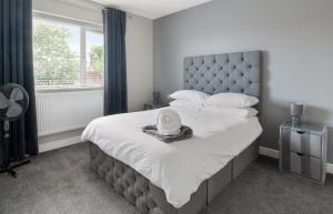 a bedroom with a large bed with a white blanket at Perfect Getaway 1 in Middlesbrough
