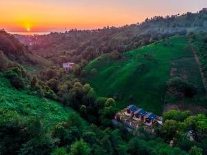 an aerial view of a house on a hill at sunset at Dolana Wadi Taş Evleri in Pirinçlik