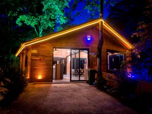 a house with lights on the front of it at night at Dolana Wadi Taş Evleri in Pirinçlik