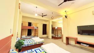 a large living room with a large flat screen tv at Platform 9 3by4 in Ujjain