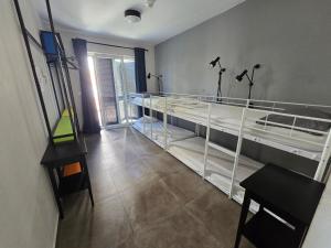 a room with two bunk beds and a table at SUBTUB Hostel Makarska in Makarska