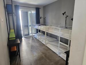 a bedroom with two bunk beds in a room at SUBTUB Hostel Makarska in Makarska