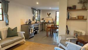 a living room with a couch and a kitchen at Bramleigh Farm in Nottingham Road +66 photos
