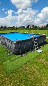 a large swimming pool with a ladder next to it at KempingZator in Zator