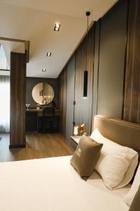 a bedroom with a bed and a vanity with a mirror at Xhasen Hotel & Café in Tirana