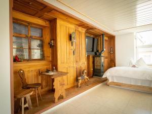 a bedroom with a bed and a desk and a television at 280m2 Luxus Loft Atrium-X 60m2 Terrasse in Rorbas