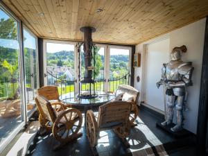 a room with a table and chairs and a statue at 280m2 Luxus Loft Atrium-X 60m2 Terrasse in Rorbas