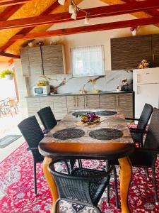a kitchen with a wooden table and chairs in a room at Superubytovanie Olga in Štrba
