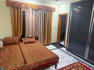 a bedroom with a bed and a large window at Galiyat Peak in Abbottabad